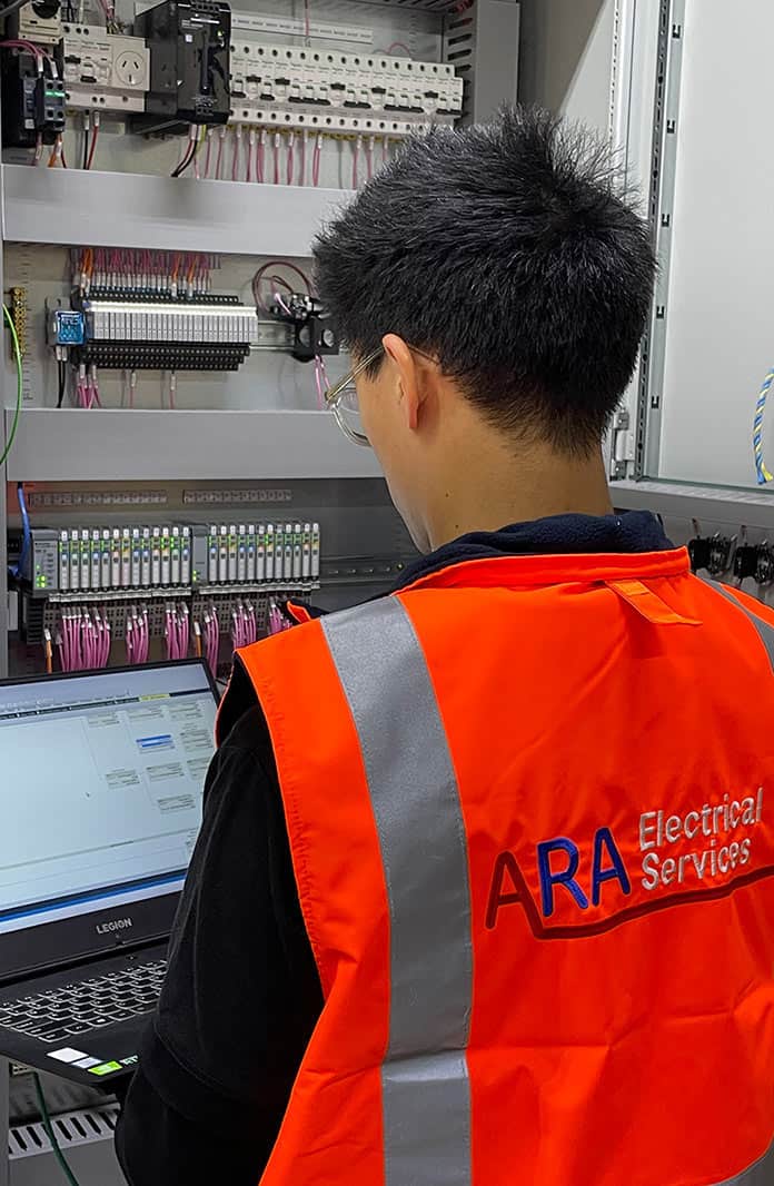 Man standing at electrical switch board Man standing at electrical switch board